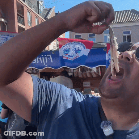 Man Eating Food In Front Of Duck Hollandse Streek Sign GIF