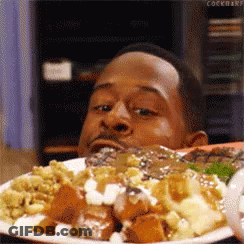 Man Eating Food With Eyes Closed GIF