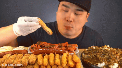 Man Eating Fried Food Including Sausage GIF