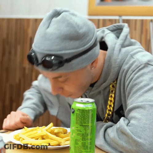 Man Eating Fries Beside Lemonade Can GIF