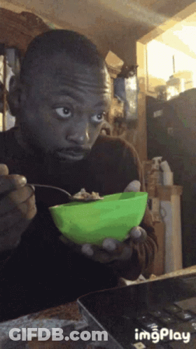 Man Eating From Green Bowl With Spoon GIF