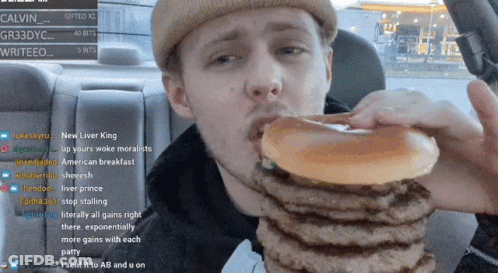 Man Eating Hamburgers In Car Watching Stream GIF