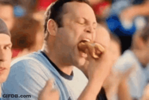 Man Eating Hot Dog At Sports Event GIF