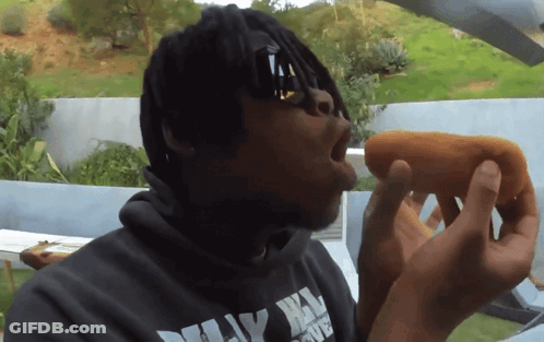 Man Eating Hot Dog In Dirty Harry Hoodie GIF