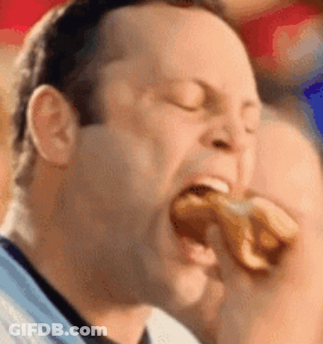 Man Eating Hot Dog With Eyes Closed GIF