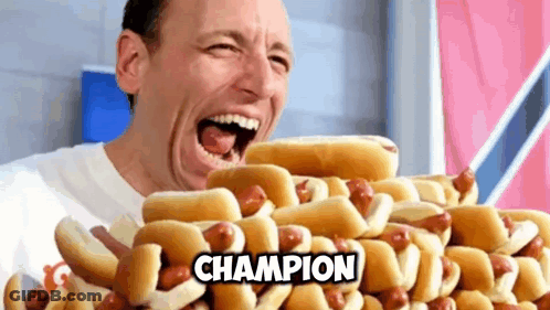 Man Eating Hot Dogs Saying Champion GIF