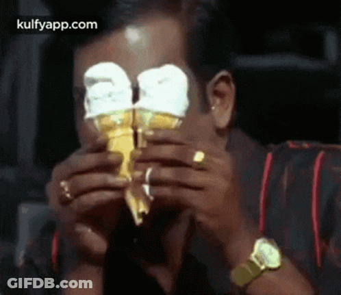 Man Eating Ice Cream Cone With Eyes Covered GIF