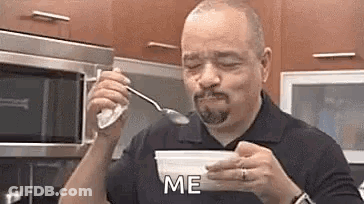 Man Eating Ice Cream From Bowl In Kitchen GIF