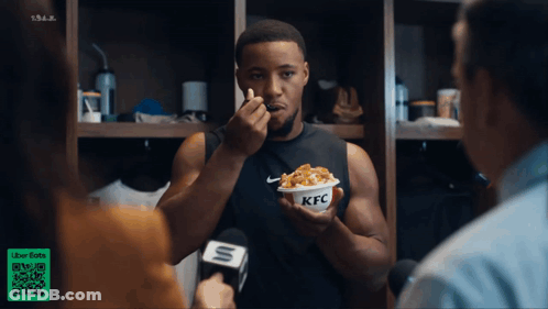 Man Eating KFC While Interviewed By Reporter GIF
