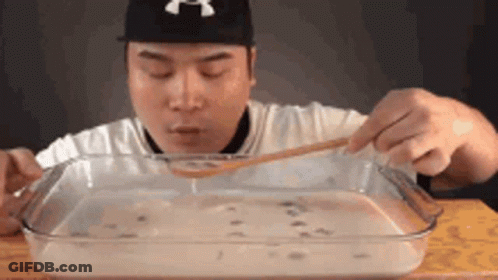 Man Eating Large Amount Of Food With Spoon GIF