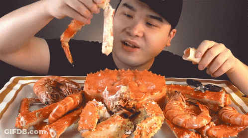 Man Eating Large Crab And Shrimp GIF