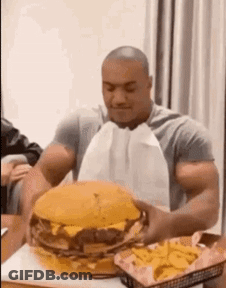 Man Eating Large Hamburger And French Fries GIF