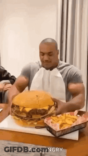 Man Eating Large Hamburger And French Fries GIF
