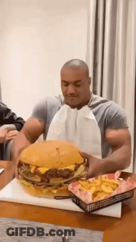 Man Eating Large Hamburger And Fries GIF