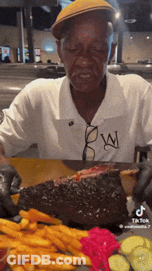 Man Eating Large Piece Of Meat GIF