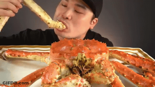 Man Eating Large Red Crab GIF