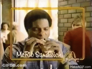 Man Eating McRib Sandwich In Restaurant GIF