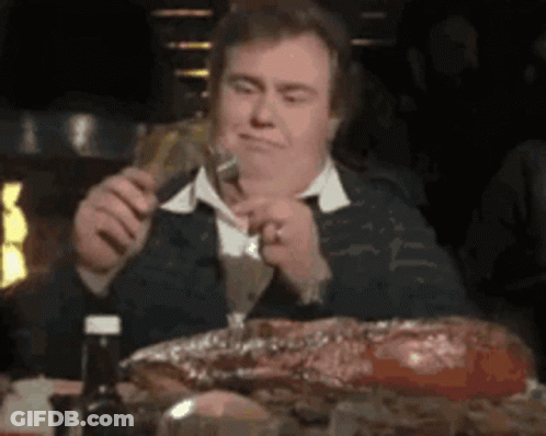 Man Eating Meat Holding Beer GIF
