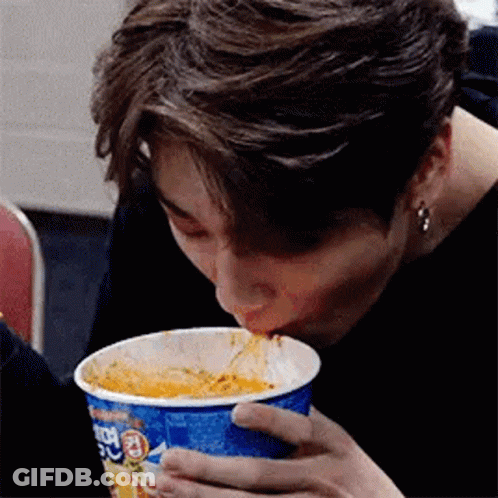 Man Eating Noodles From Blue Cup GIF