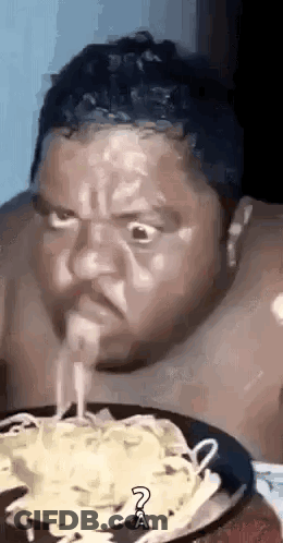 Man Eating Noodles From Plate GIF
