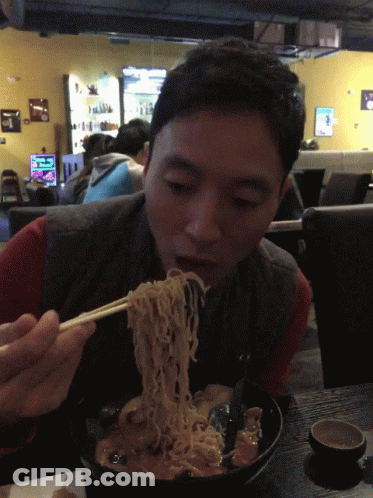 Man Eating Noodles With Chopsticks In Cafe GIF