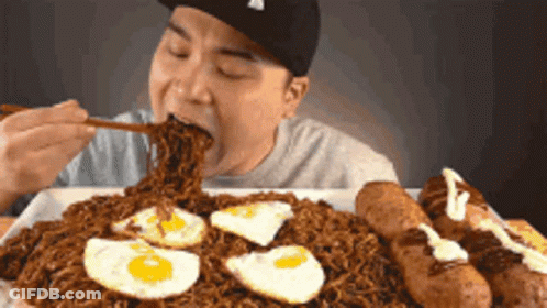 Man Eating Noodles With Eggs And Sausages GIF