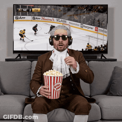 Man Eating Popcorn And Watching Hockey GIF
