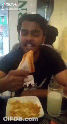 Man Eating Sandwich And Drinking Milk At Restaurant GIF