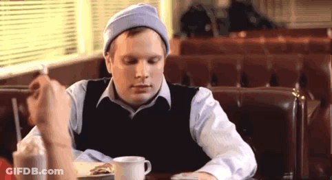 Man Eating Sandwich And Drinking Milkshake In Diner GIF