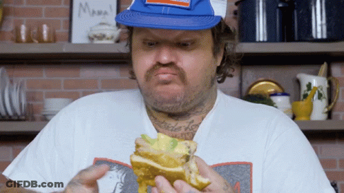 Man Eating Sandwich In Front Of Mama Sign GIF