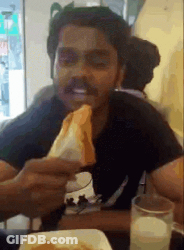 Man Eating Sandwich With Glass Of Milk GIF