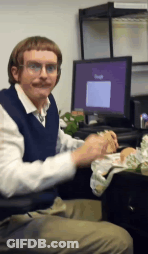 Man Eating Sandwich With Google On Screen GIF