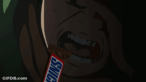 Man Eating Snickers Bar In Dark Room GIF