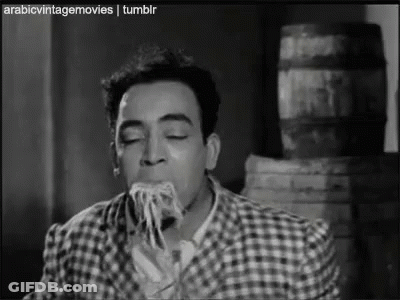 Man Eating Spaghetti In Black And White GIF