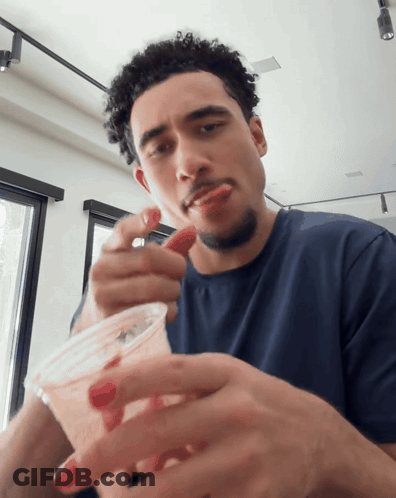 Man Eating Strawberry From Cup GIF