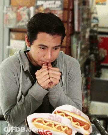 Man Eating Two Hot Dogs With Mustard Big Boy GIF