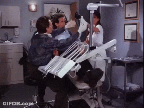 Man Examined By Dentist And Nurse In Dental Chair GIF