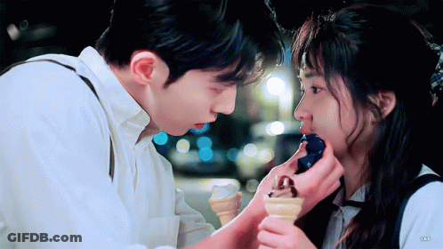 Man Feeding Woman Ice Cream Cone GIF