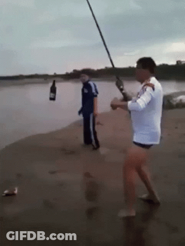 Man Fishing On Beach With Bottle GIF