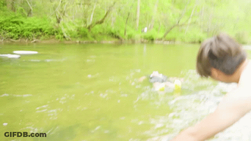 Man Fishing While Another Man Swimming GIF