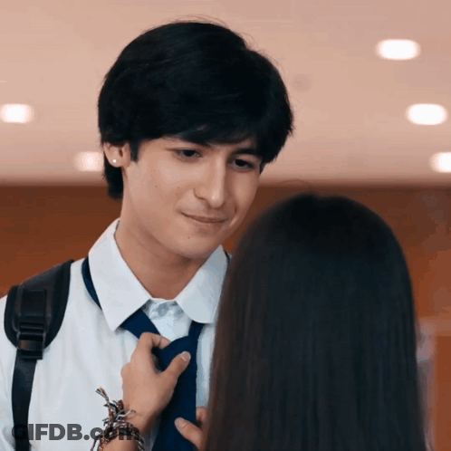 Man Fixing Woman's Tie GIF