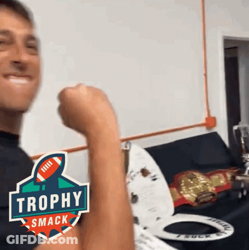 Man Flexing Arm With Trophy Smack Logo GIF