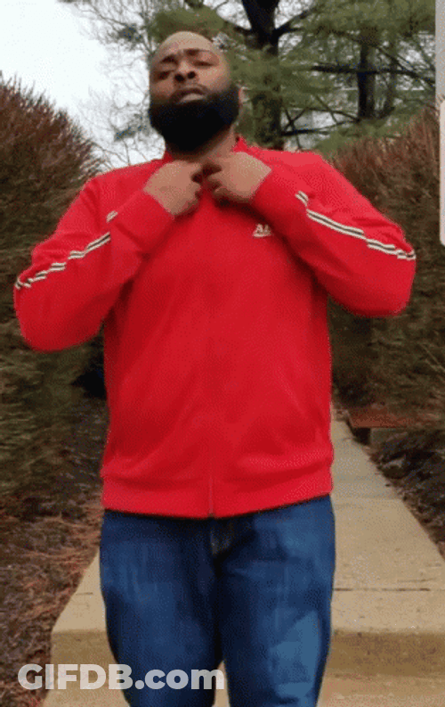 Man Flexing His T-Shirt With 100 Logo GIF