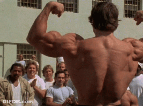 Man Flexing Muscles In Front Of Crowd GIF