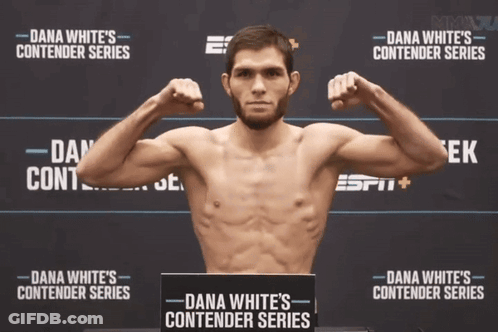 Man Flexing Muscles In Front Of Dana White Contender Series Poster GIF