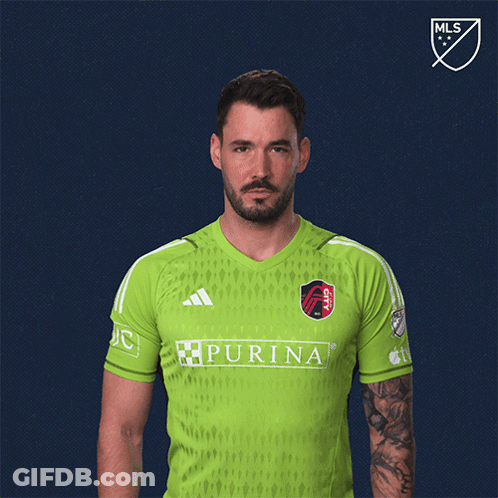Man Flexing Muscles In Green Purina Shirt GIF