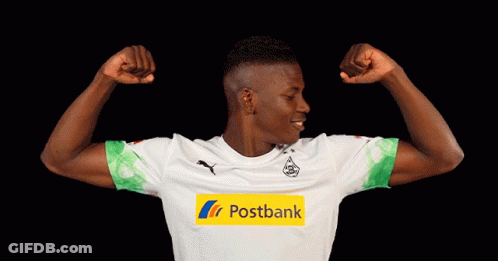 Man Flexing Muscles In Postbank Jersey GIF