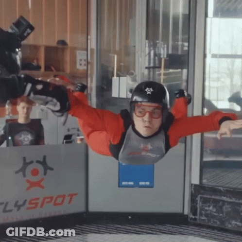 Man Flying In Front Of Flyspot Sign GIF