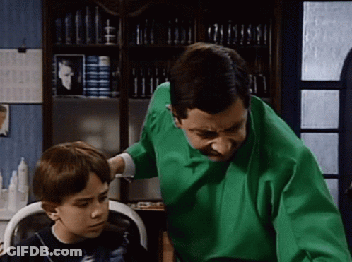 Man Getting Haircut At Barber Shop In Striped Cape GIF