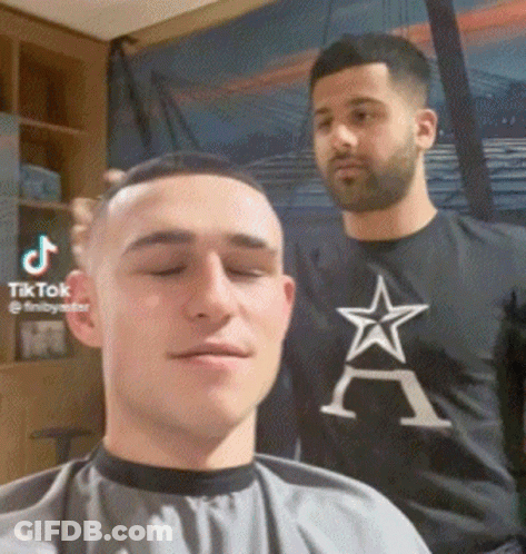 Man Getting Haircut By Barber In Black Star Shirt GIF